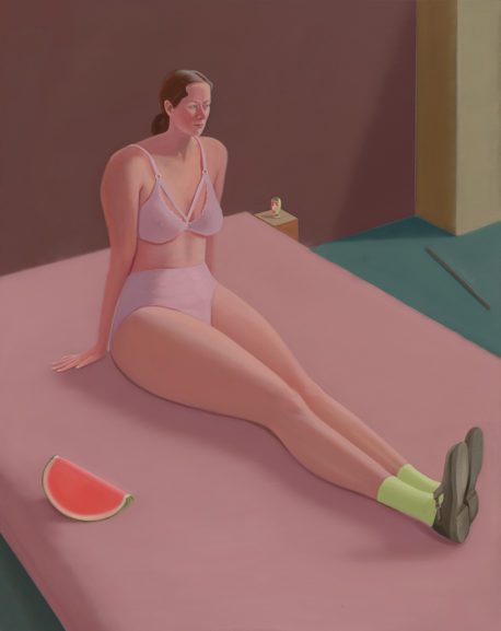 portrait of a woman sitting on bed