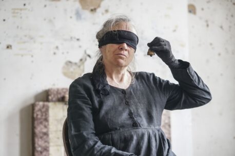 Image shows artist Marilyn Arsem, blindfolded. Photo by Fenia Kotsopoulou